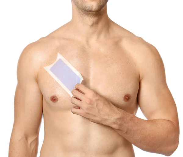 Handsome young man with wax strip on chest against white background — Stock Photo, Image