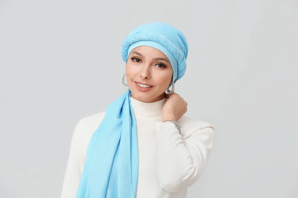 Portrait of beautiful Muslim woman on light background — Stock Photo, Image