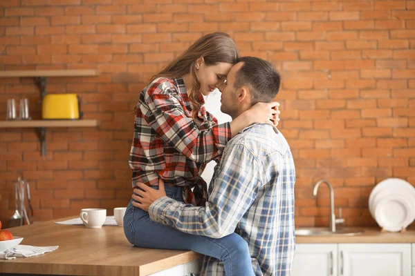 Happy young couple in kitchen at home