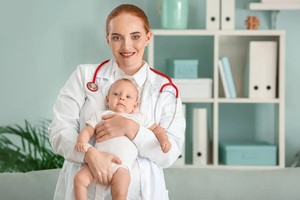 Pediatra con lindo bebé en la clínica —  Fotos de Stock