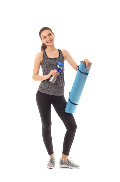 Sporty young woman with yoga mat and bottle of water on white background — Stock Photo, Image