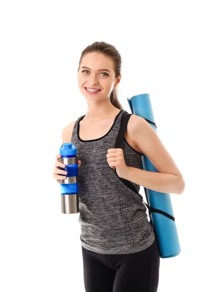 Sporty young woman with yoga mat and bottle of water on white background — Stock Photo, Image