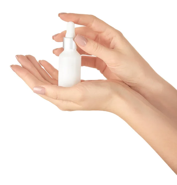 Female hands with cosmetic product in bottle on white background — Stock Photo, Image