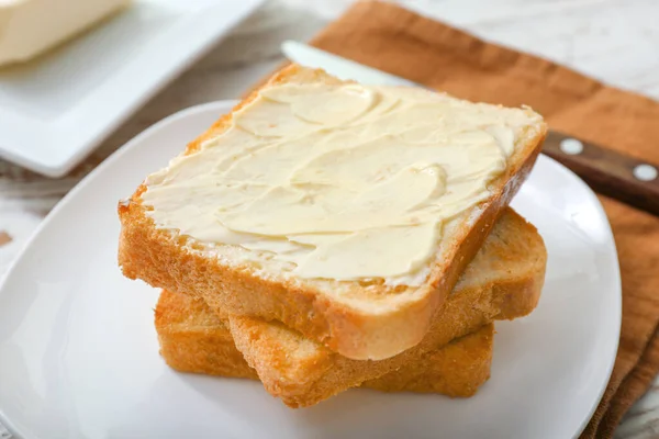 Tasty toasted bread with butter on plate, closeup — Stock Photo, Image
