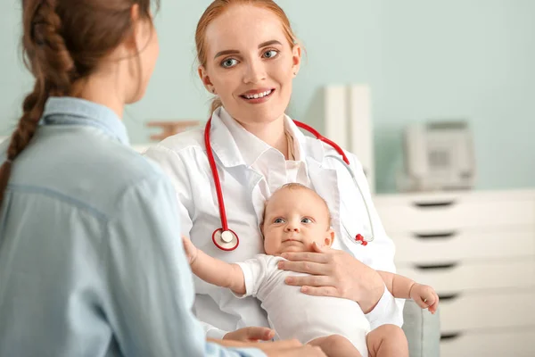 Woman with little baby visiting pediatrician in clinic Stock Photo