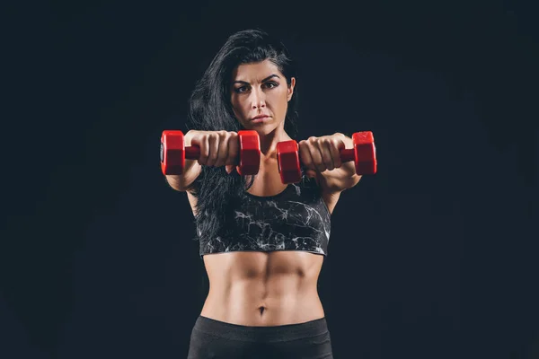 Sporty muscular woman with dumbbells on dark background — Stock Photo, Image