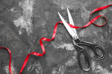 Grunge arka planında makas ve kırmızı kurdele