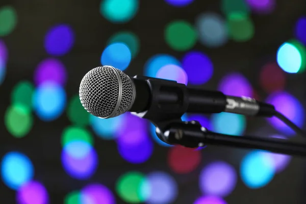 Microphone on dark background with defocused lights — Stock Photo, Image