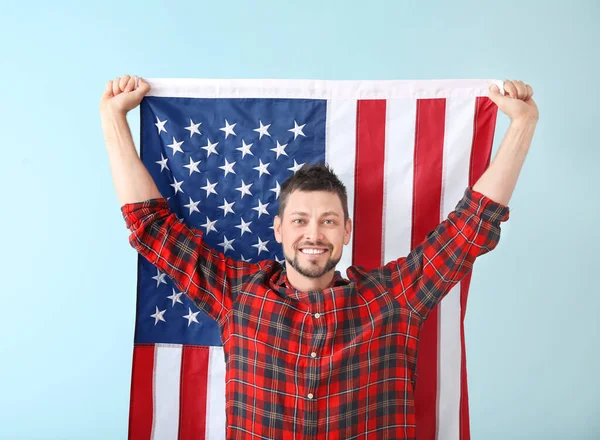 Handsome man with USA flag on color background. Memorial Day celebration — Stock Photo, Image