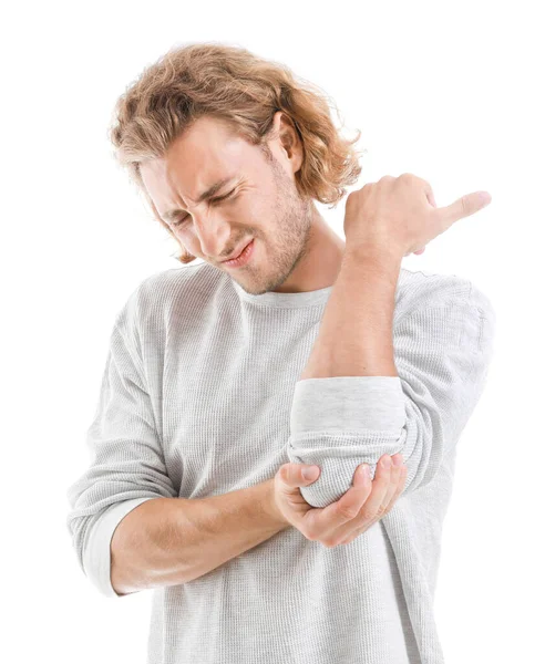 Young man suffering from pain in elbow on white background — Stock Photo, Image