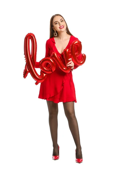 Schöne junge Frau mit Luftballon in Form von Wort Liebe auf weißem Hintergrund. Valentinstag-Feier — Stockfoto