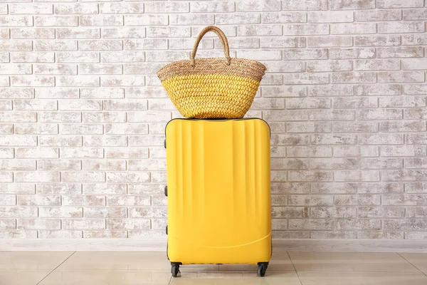 Suitcase and beach bag near brick wall. Travel concept — Stock Photo, Image