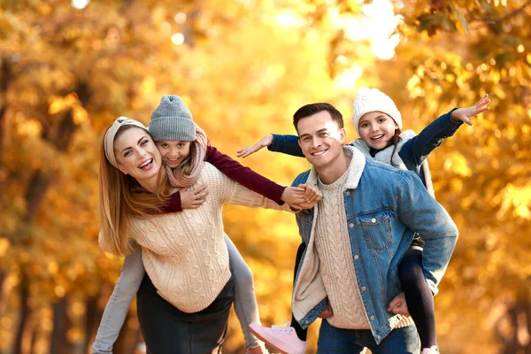 Portrait of happy family in autumn park — Stock Photo, Image