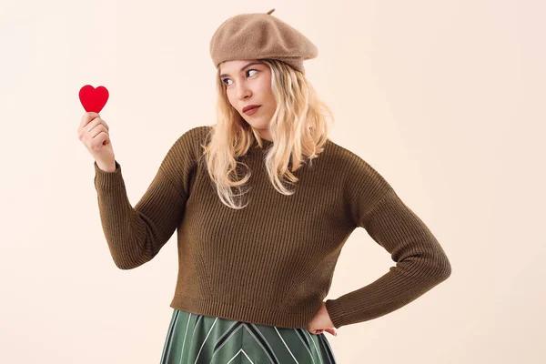 Beautiful young woman with small red heart on color background — Stock Photo, Image