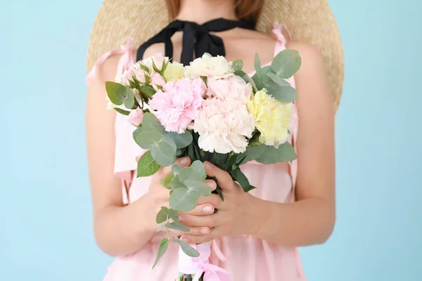 Beautiful young woman with bouquet of carnation flowers on color background, closeup — Stock Photo, Image