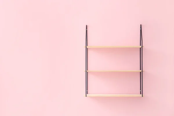 Empty shelf hanging on color wall — Stock Photo, Image