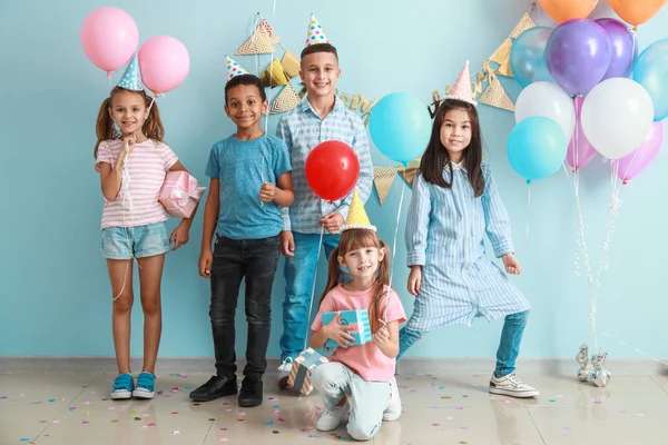 Little children with Birthday gifts and air balloons on color background — Stock Photo, Image