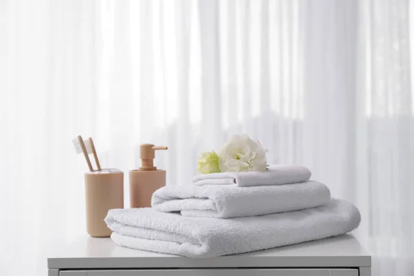 Handuk lembut, sikat gigi dan sabun di atas meja dekat jendela — Stok Foto
