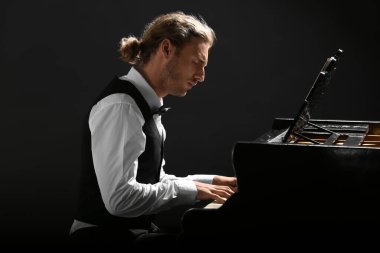 Konserde kuyruklu piyano çalan adam