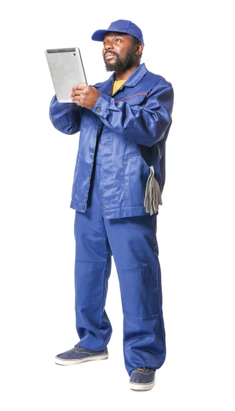 African-American car mechanic with tablet computer on white background — Stock Photo, Image