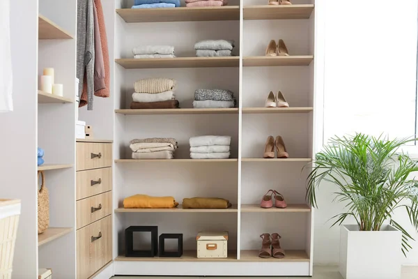 Wardrobe with stacks of clean clothes — Stock Photo, Image