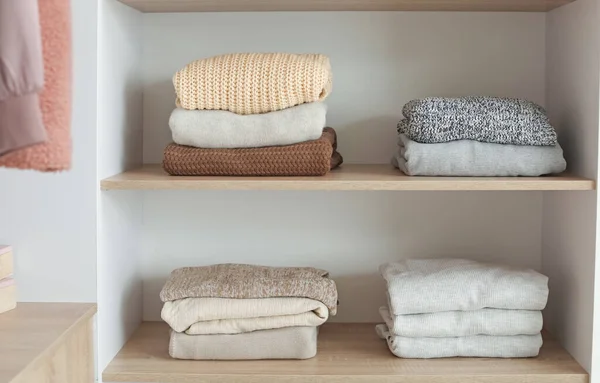 Wardrobe with stacks of clean clothes — Stock Photo, Image