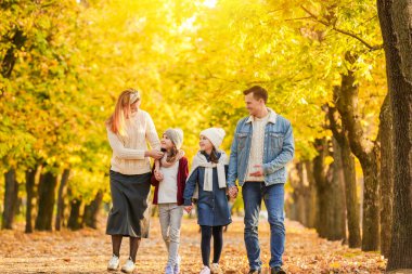 mutlu bir aile sonbahar parkta yürüyüş