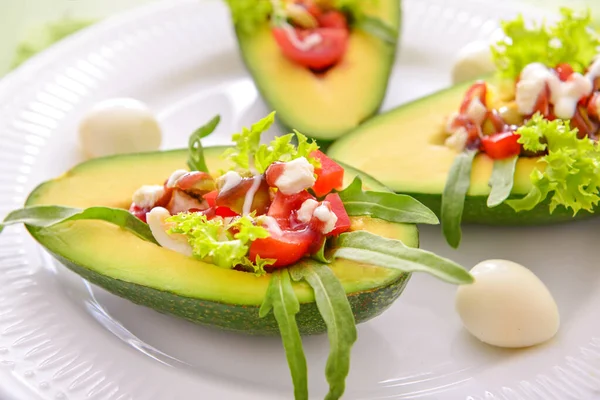 Tasty avocado with filling on plate, closeup — Stock Photo, Image