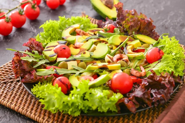 Plate with tasty avocado salad on table — Stock Photo, Image