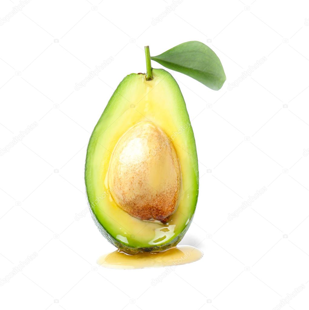 Half of ripe avocado with honey on white background