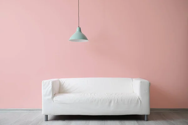 Stylish sofa near color wall — Stock Photo, Image