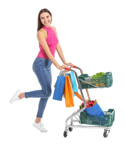 Young woman with shopping cart on white background — Stock Photo, Image