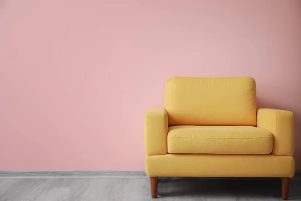 Stylish armchair near color wall — Stock Photo, Image