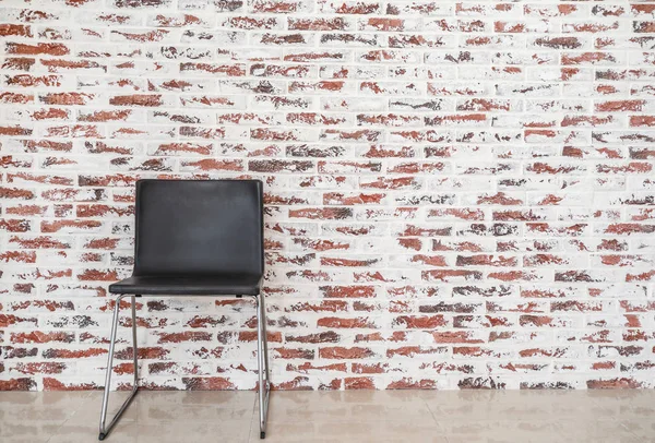 Cozy chair near brick wall in room — Stock Photo, Image