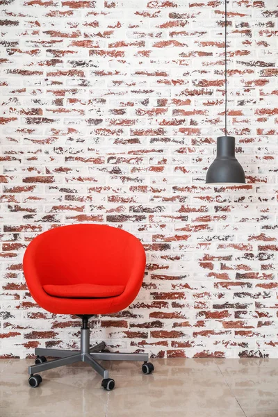 Cozy armchair with lamp near brick wall in room — Stock Photo, Image