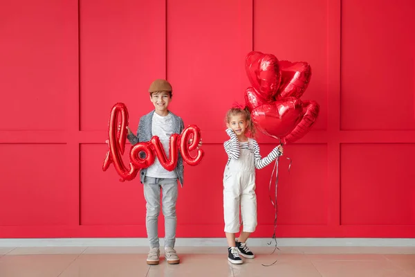 Cute little children with air balloons on color background. Valentines Day celebration — Stock Photo, Image