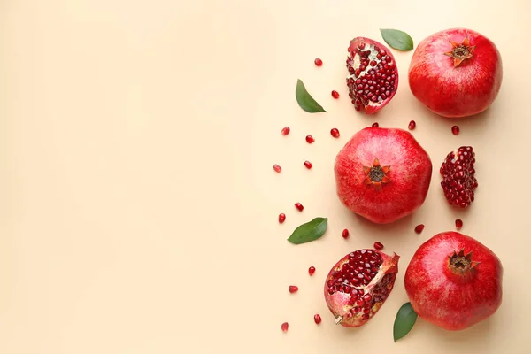 Ripe tasty pomegranates on color background — Stock Photo, Image