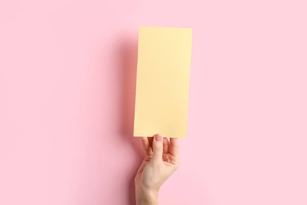 Vrouwelijke hand met blanco menu op kleur achtergrond — Stockfoto