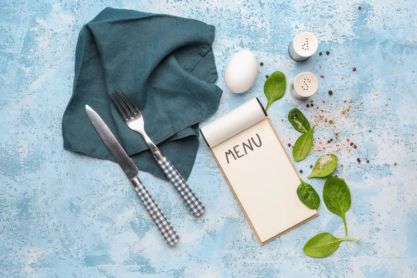 Blank menu, cutlery and spices on color background — Stock Photo, Image