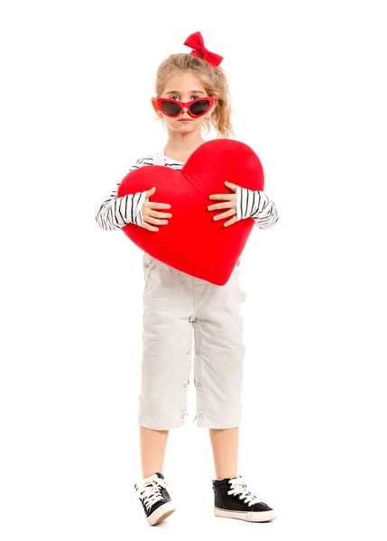Cute little girl with pillow in shape of heart on white background. Valentines Day celebration — 图库照片
