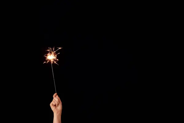 Mão feminina com brilho de Natal no fundo escuro — Fotografia de Stock