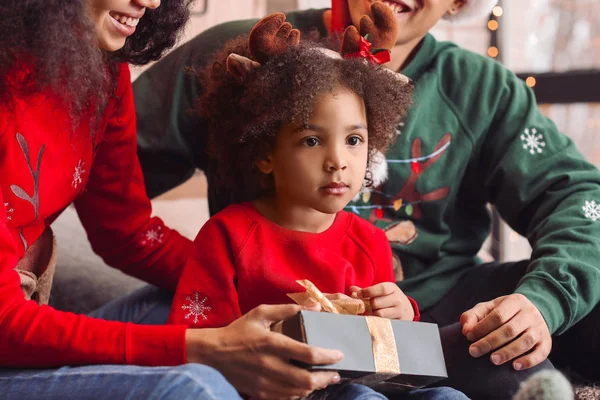 Happy African-American family with gift at home on Christmas eve — Stock Photo, Image