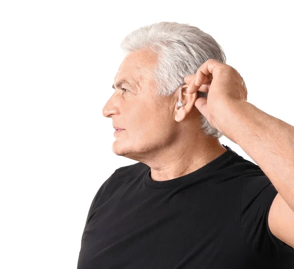 Mature man with hearing aid on white background — Stock Photo, Image