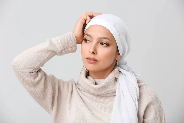 Portrait of beautiful Muslim woman on light background — Stok Foto