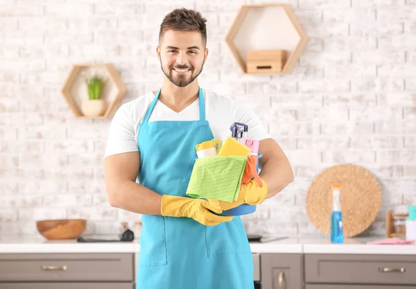 Male janitor with cleaning supplies in kitchen — Stock Photo, Image