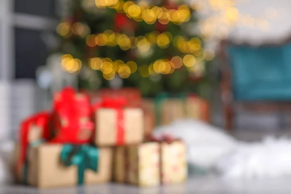 Many Christmas gifts on floor in room, blurred view — Stock Photo, Image