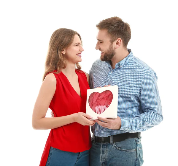Happy young couple with gift on white background. Valentine's Day celebration — Stock Photo, Image
