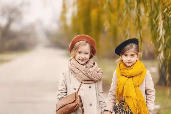 Cute little girls in autumn clothes outdoors — Stock Photo, Image