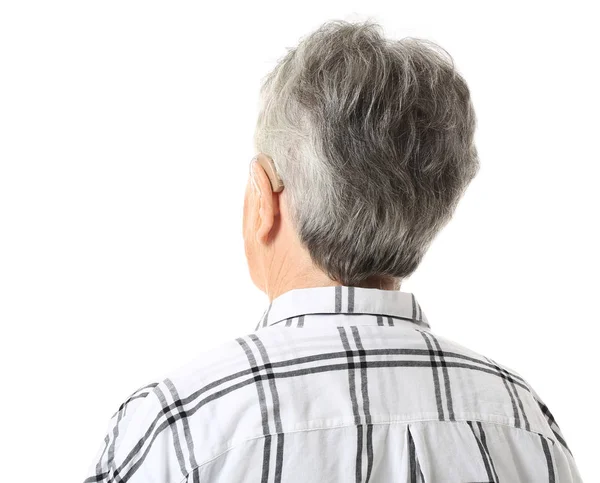 Senior woman with hearing aid on white background — Stock Photo, Image