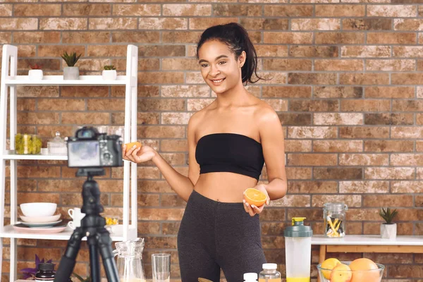 African-American blogger recording video about sport and healthy food at home — Stock Photo, Image